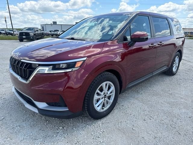 2023 Kia Carnival LX in Flare Red — front three-quarter view