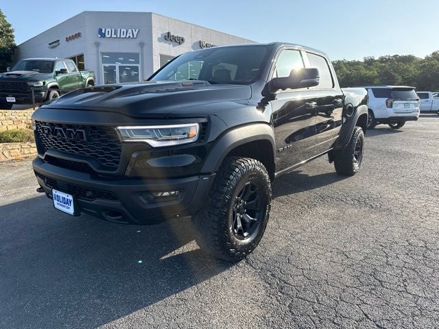 2026 RAM Ram 1500 RAM 1500 RHO CREW CAB 4X4 5'7' BOX in Diamond Black Crystal Pearl-Coat Exterior Paint — front three-quarter view